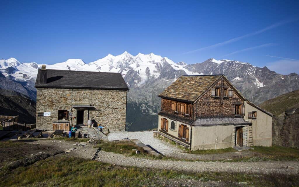 Weissmieshütte with the 4,000 metre peaks of Saas Fee in the background, summer.